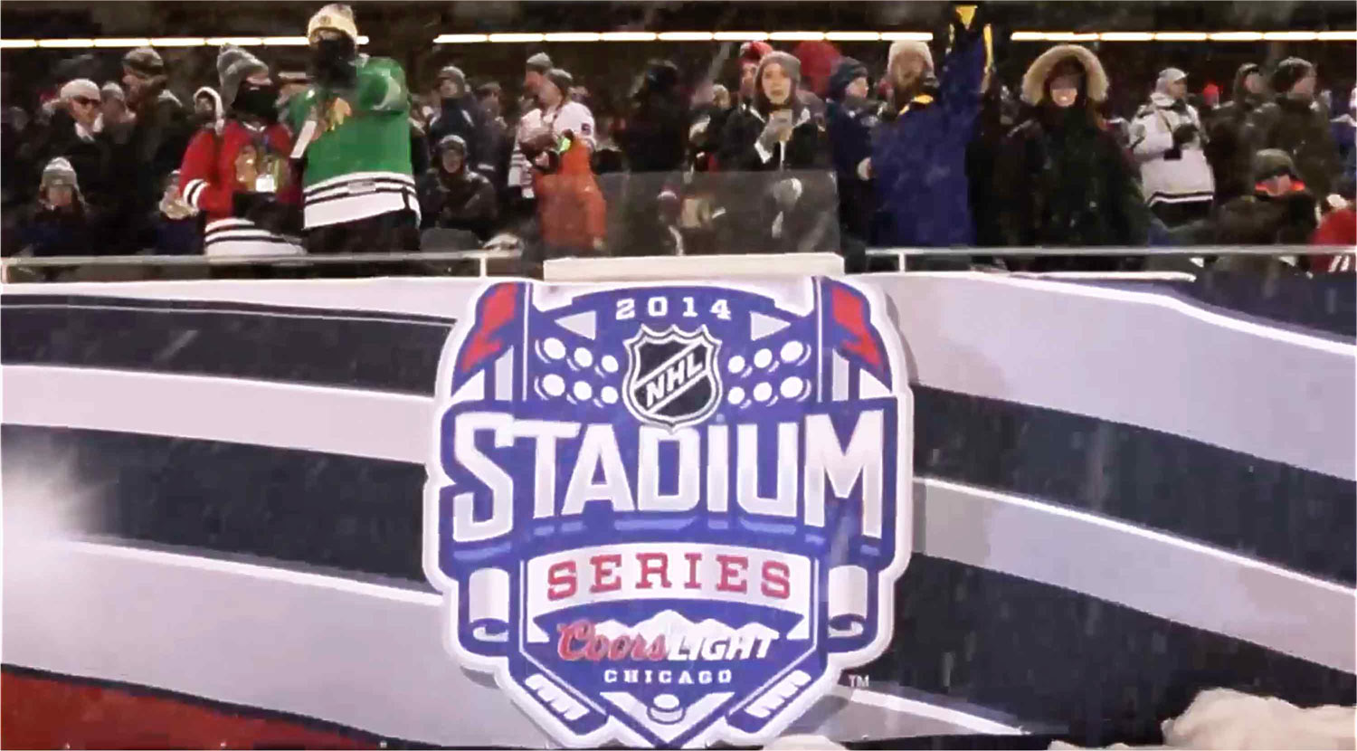 2014 NHL Stadium Series Chicago logo graphic on the rink-side boards with fans behind
